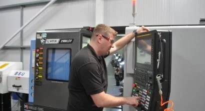 Operator at the controls of a Lynx 2100LSYB at Herriott Precision